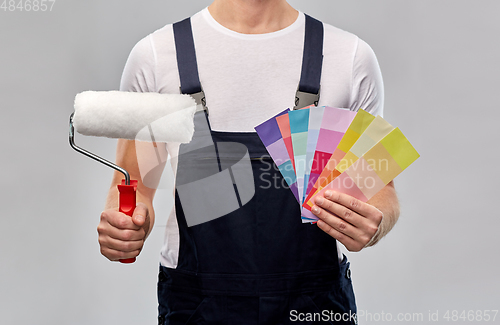 Image of close up of painter with roller and color charts