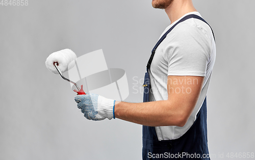 Image of close up of painter or builder with paint roller