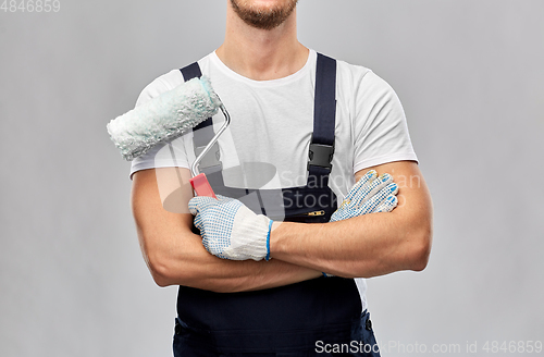 Image of close up of painter or builder with paint roller