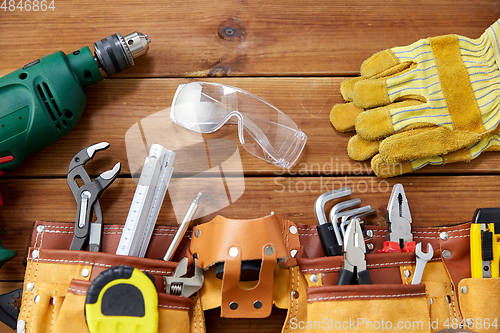 Image of different work tools on wooden boards