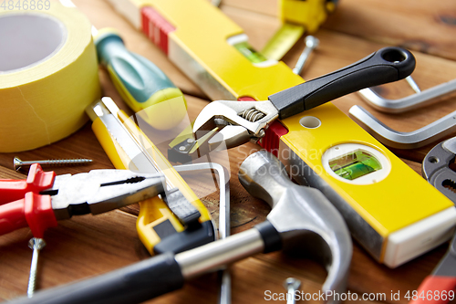 Image of different work tools on wooden boards background