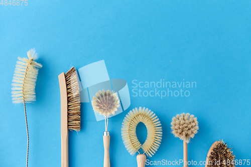 Image of different cleaning brushes on blue background