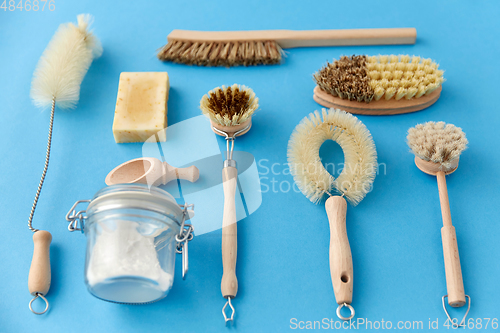 Image of cleaning brushes and soda powder with scoop in jar