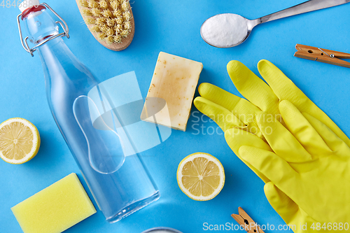 Image of vinegar, lemons, washing soda, gloves and brush