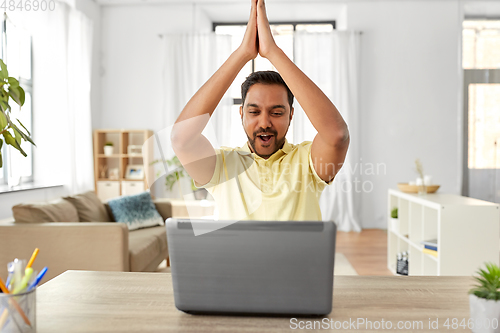 Image of indian man with laptop working at home office