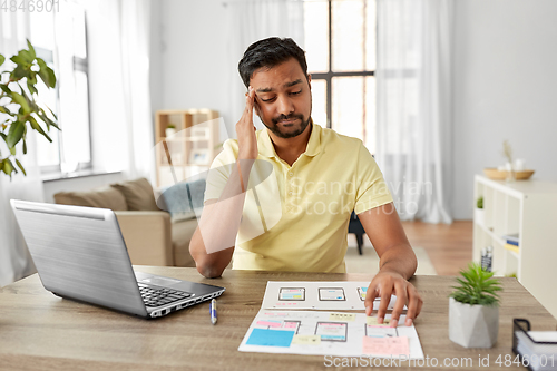 Image of male ui designer working on user interface at home