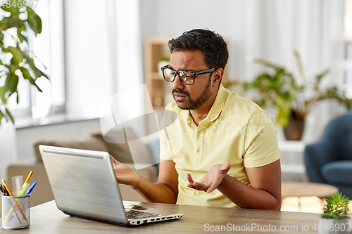 Image of sad man with laptop working at home office