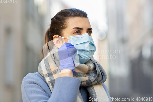 Image of young woman wearing protective medical mask