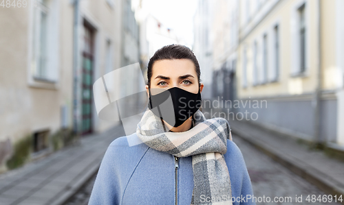 Image of woman wearing protective reusable mask in city