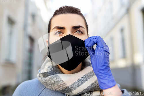 Image of woman wearing protective reusable mask in city