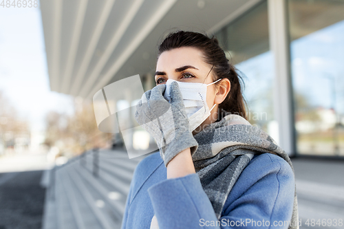 Image of woman wearing protective medical mask in city