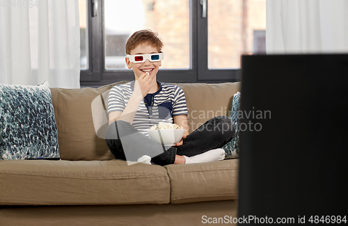 Image of boy in 3d movie glasses and watching tv at home