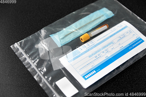 Image of beaker with test, cotton swab and medical report