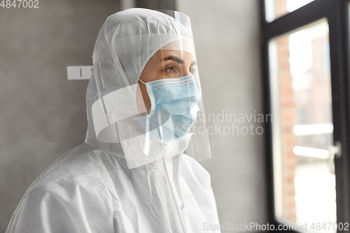 Image of doctor in protective wear, mask and face shield