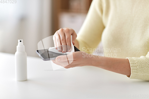 Image of close up of woman cleaning smartphone