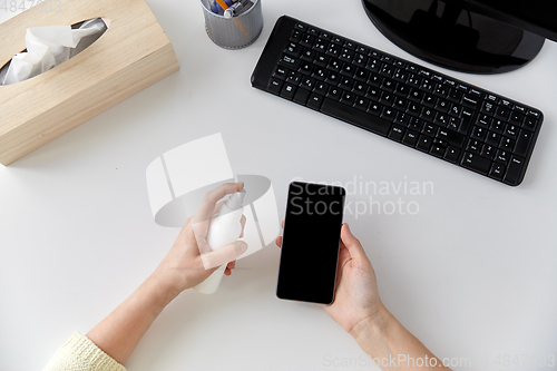 Image of close up of woman cleaning smartphone