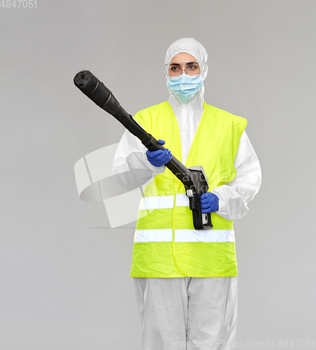 Image of sanitation worker in hazmat with pressure washer