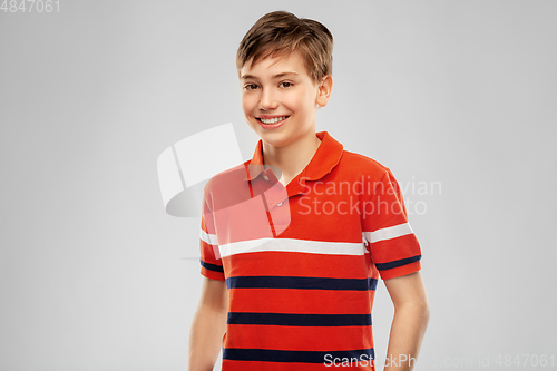 Image of portrait of happy smiling boy in red polo t-shirt