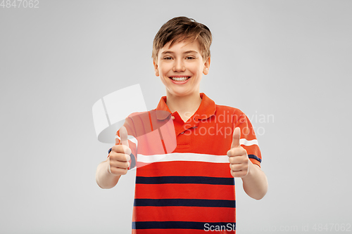 Image of happy boy in red polo t-shirt showing thumbs up