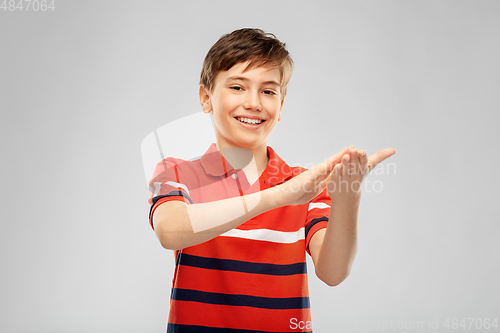 Image of portrait of happy smiling boy applauding
