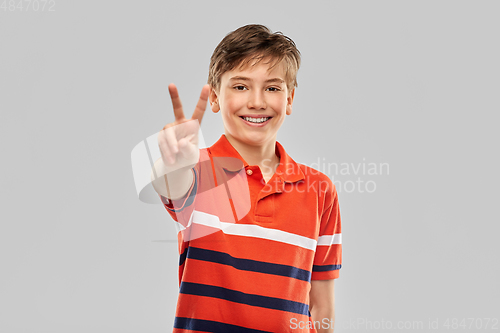 Image of portrait of happy smiling boy in red polo t-shirt