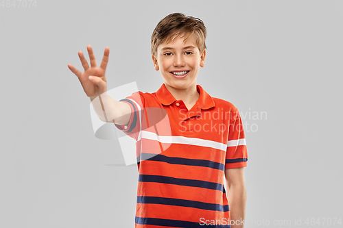 Image of portrait of happy smiling boy showing four fingers