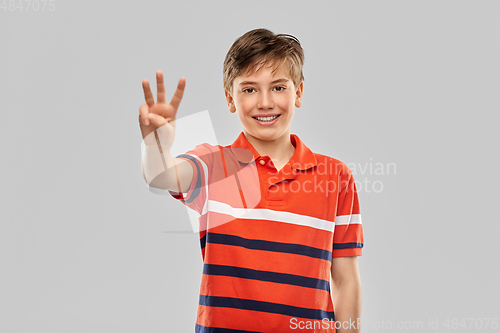 Image of portrait of smiling boy showing three fingers