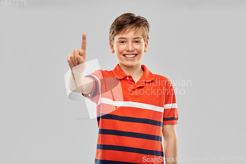 Image of portrait of happy smiling boy showing one finger
