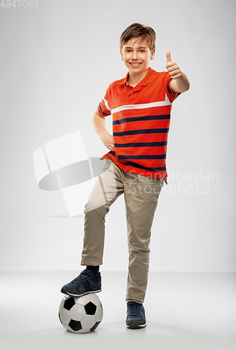 Image of happy boy with soccer ball showing thumbs up