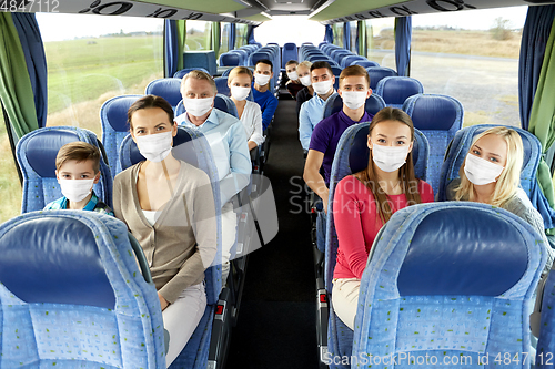 Image of group of passengers in masks travelling by bus