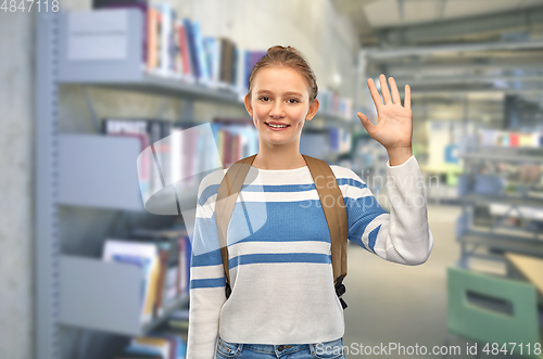 Image of smiling teenage student girl with school bag