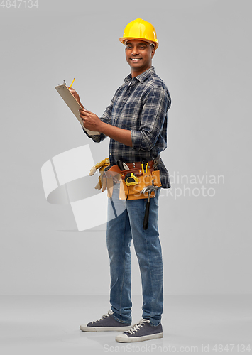 Image of happy builder with clipboard and pencil