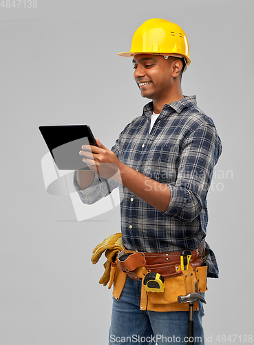 Image of happy indian builder in helmet with tablet pc