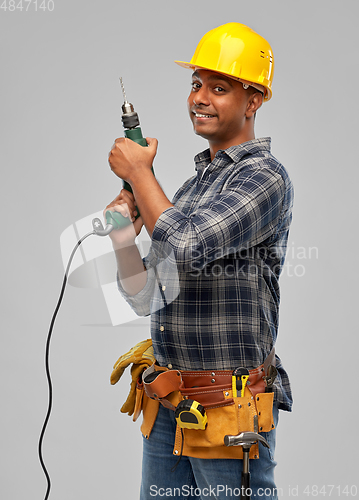 Image of happy indian builder in helmet with electric drill