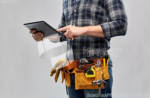 Image of male builder with tablet pc and working tools