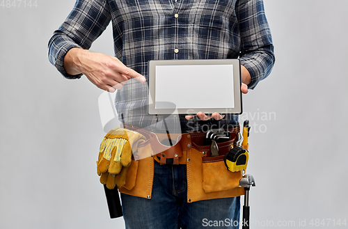 Image of male builder with working tools showing tablet pc