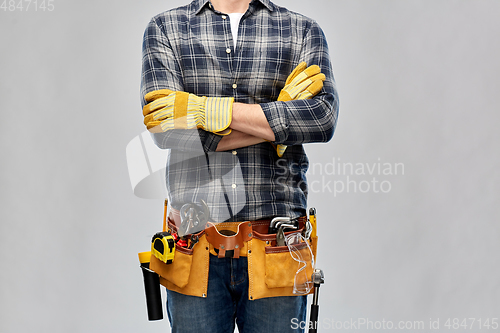 Image of builder with working tools, goggles and gloves on