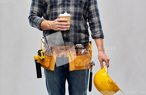 Image of male builder with coffee, helmet and working tools