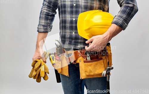 Image of worker or builder with helmet and working tools