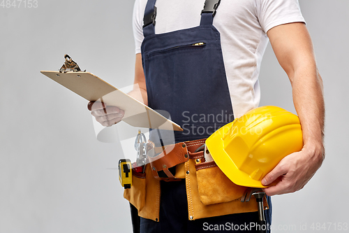 Image of male builder with clipboard and working tools