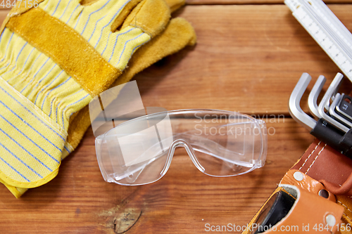 Image of different work tools in belt on wooden boards