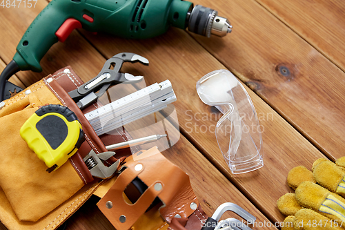 Image of different work tools on wooden boards