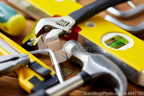 Image of different work tools on wooden boards background