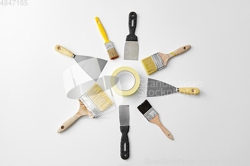 Image of different size paint brushes and putty knives