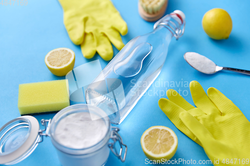 Image of vinegar, lemons, washing soda, gloves and brush