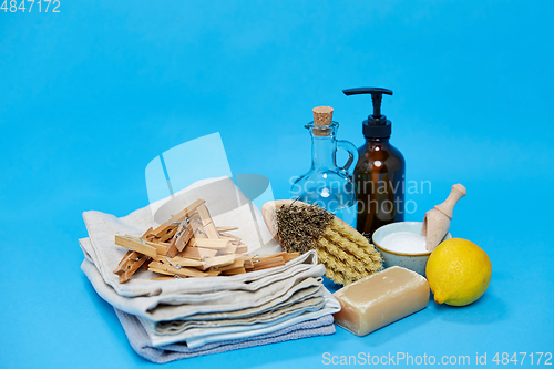 Image of baking soda, lemon, brush, vinegar and clothespins