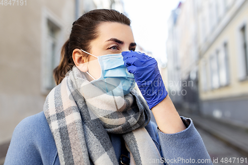 Image of woman wearing protective medical mask in city