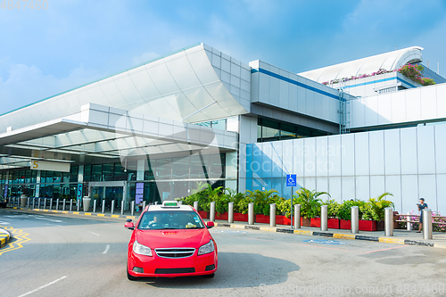 Image of Taxi cab by airport terminal