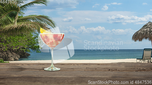 Image of Summer refreshing cocktail with sea or ocean beach on background