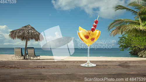 Image of Summer refreshing cocktail with sea or ocean beach on background